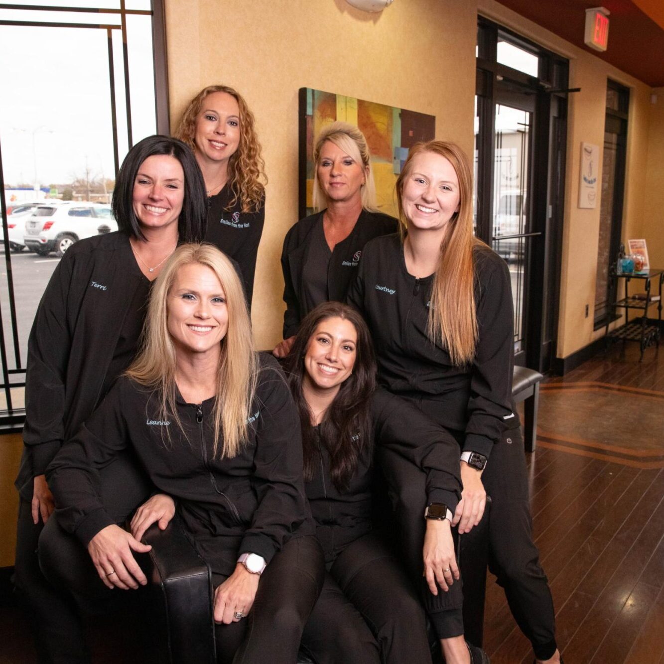 Middle Tennessee orthodontic team at Smiles from the Hart, smiling in black scrubs, showcasing friendly service and community connection.